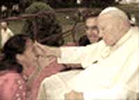 John Paul II touching the forehead of a young woman